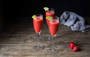 strawberry daiquiris with lime garnish