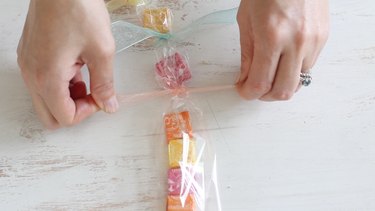 Tying ribbon between each candy piece