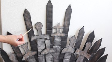 Dry brushing copper paint onto spikes