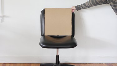 Cardboard cut to size of chair back