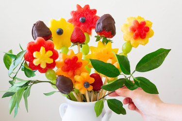 Insert citrus leaves around base of the vase to fill in bare spots