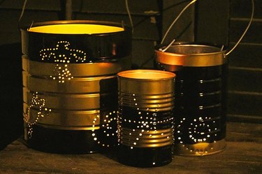 Three artistic DIY lanterns made from empty cans