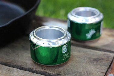 Two soda cans, converted into DIY camp stoves