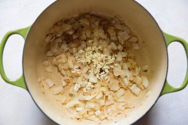 onion and garlic sauteing in a stock pot.