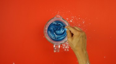 Adding food coloring to starch mixture for  DIY Sidewalk Squirt Chalk