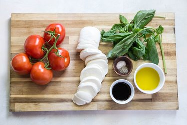 ingredients for caprese salad on a cutting board