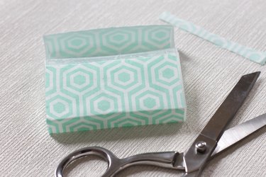 Transform empty plastic gum holders into first aid kits, sewing kits, gift card holders, and q-tip holders.