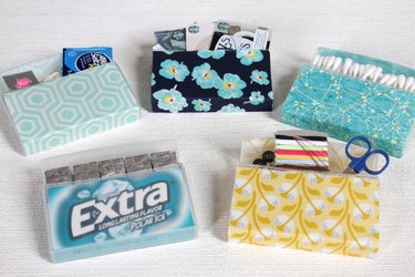 Transform empty plastic gum holders into first aid kits, sewing kits, gift card holders, and q-tip holders.