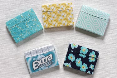 Transform empty plastic gum holders into first aid kits, sewing kits, gift card holders, and q-tip holders.