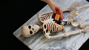 Placing candy inside skeleton