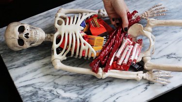 Placing candy inside skeleton