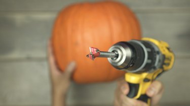 Using a Forstner drill bit to cut a hole into a pumpkin