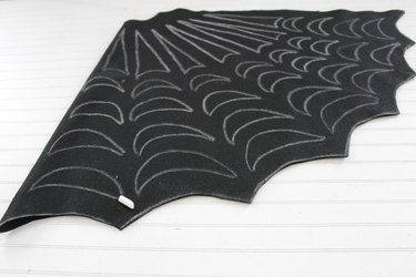 Draw on a spooky spiderweb pattern