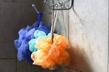 colorful loofahs hanging in shower
