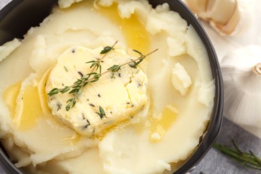 Compound herb butter on mashed potatoes