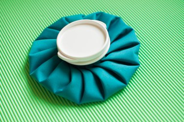 A flat lay of a green ice pack on a green background
