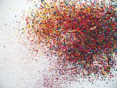 Close-Up Of Colorful Crayon Shavings Over White Background