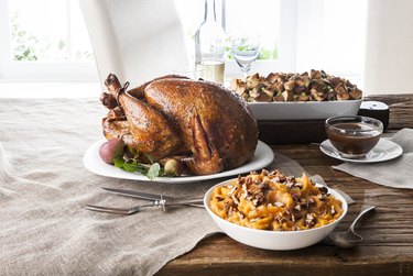 Stuffing, sweet potatoes and smoked turkey on wooden table