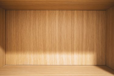 Interior of wooden cabinet under light