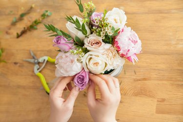 Crop hands of florist making bouquet