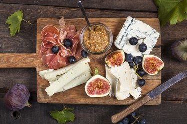 Cheese platter with fruits and fig mustard