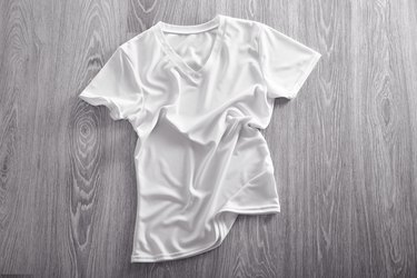 Blank white t-shirt on wooden background