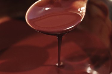 Close-Up Of Spoon Over Melted Chocolate