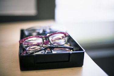 Several pairs of glasses in a box at the optometrist