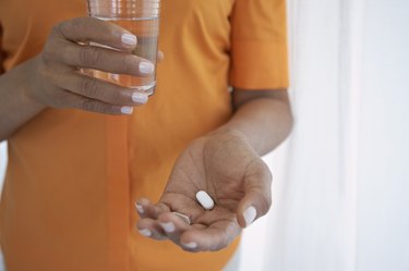 female hands with pill.