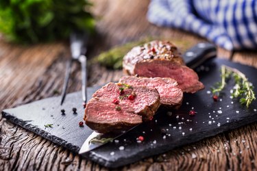 Beef Steak. Roasted Beef steak with salt pepper thyme on rustic wooden table