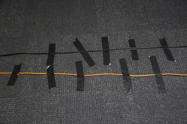 High angle view of cables attached on carpet