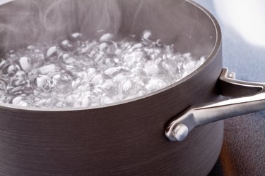 Water boiling in a pot on the stove top