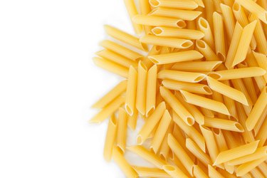 dry pasta penne Italian food white background.