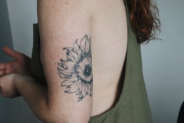 Young female arm with tattoo