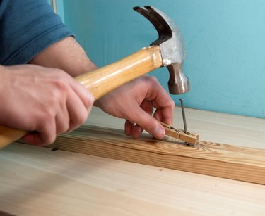 Holding a nail with a clothes peg