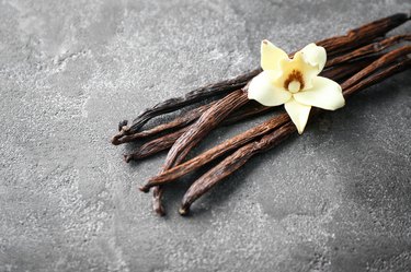 Vanilla sticks and flower on grey background