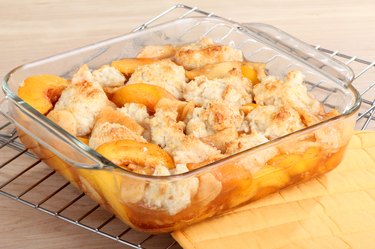 Peach cobbler in a clear square dish