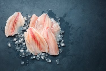 Fresh fish fillet of sea bass in ice.