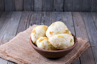 Traditional dumplings with onion on a wooden table