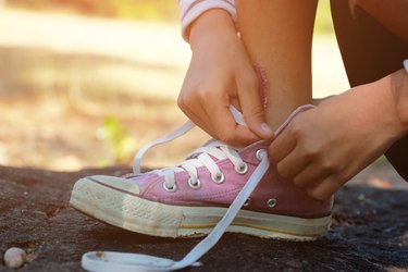 Low Section Of Girl Tying Shoelace