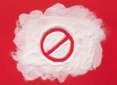 Stop prohibition sign on white sugar background