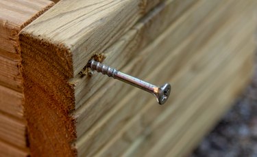 High Angle View Of Screw Mounted In Wooden Seat