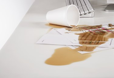 Close up of coffee spilled on paperwork