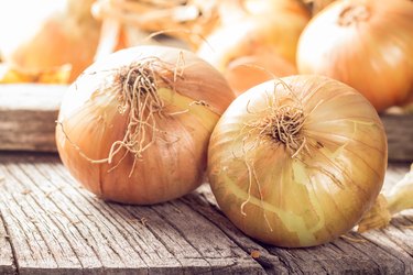 Fresh onions on wooden table