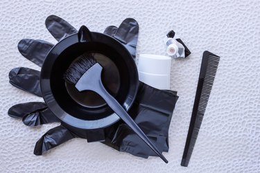 Mixing hair dye in a special plastic bowl. Concept is hair coloring.