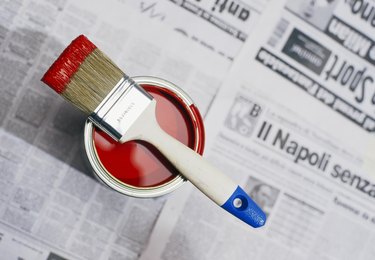 Red paint on a newspaper.