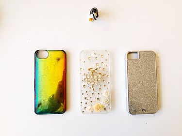 High Angle View Of Smart Phone Covers On White Table