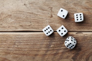 White dice on wooden table. Gambling devices. Game chance concept.