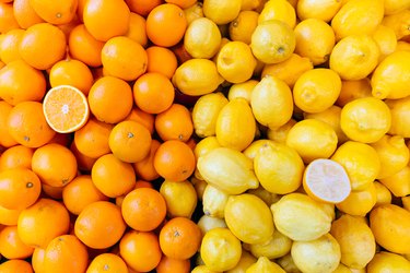 Fresh oranges and lemons in a market stall