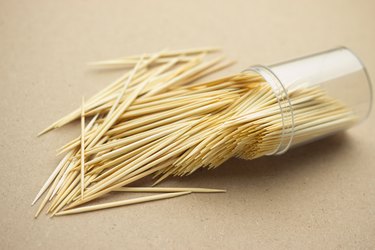 High Angle View Of Toothpick In Container On Table